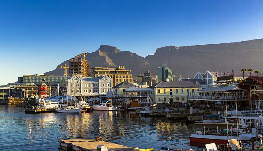 boats in the harbour of cape town with table mountain in the background