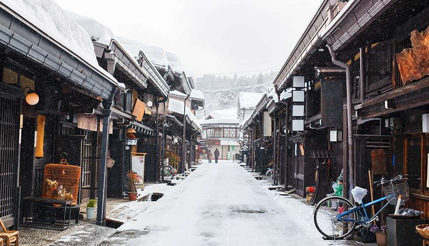 old wooden houses in Takayama in Japan covered in snow