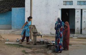 Working the water pump in Basari Working the water pump in Basari