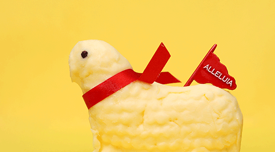 butter lamb with red flag and ribbon on yellow background for bizaare easter traditions