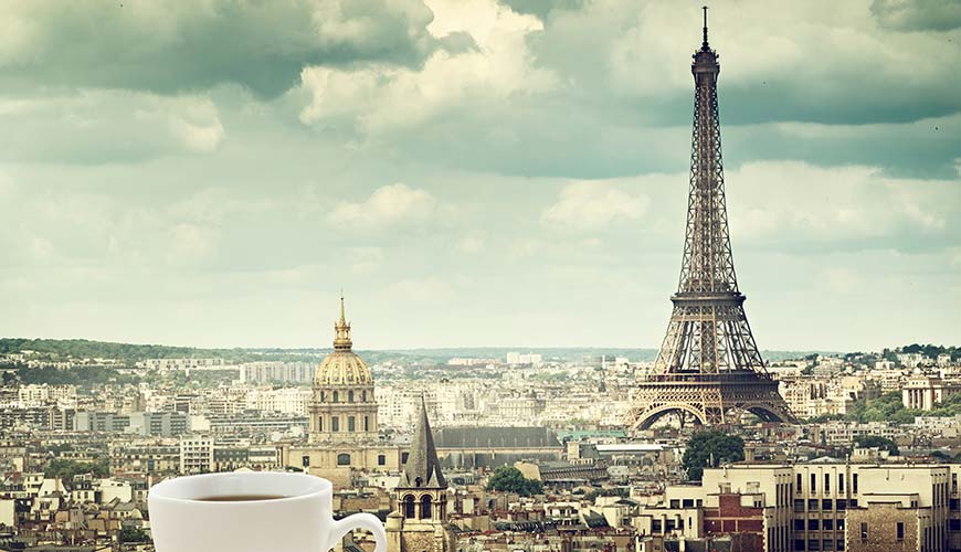 Cup of coffee in a rooftop cafe looking at the Eiffel Tower in Paris France