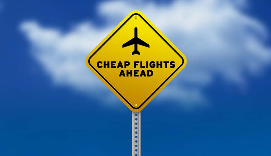 road sign with title "cheap flights ahead"