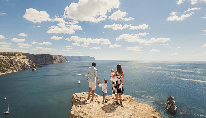 happy family walking by the water, travel experiences for families