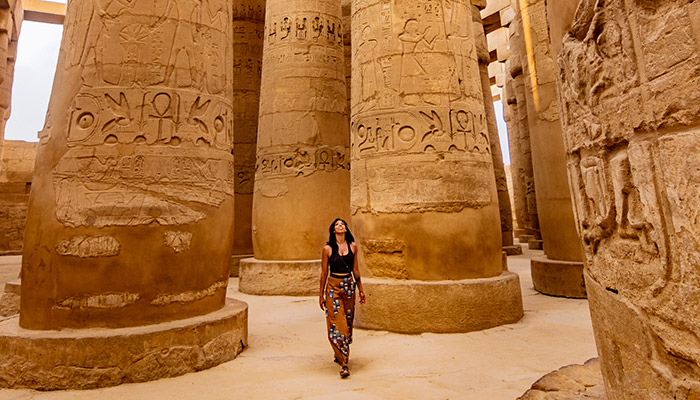 Solo traveller exploring the ancient Karnak Temple, one of the best places to go in April