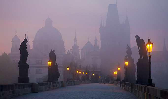 Charles Bridge on a foggy autumn day, one of the best places to visit in October