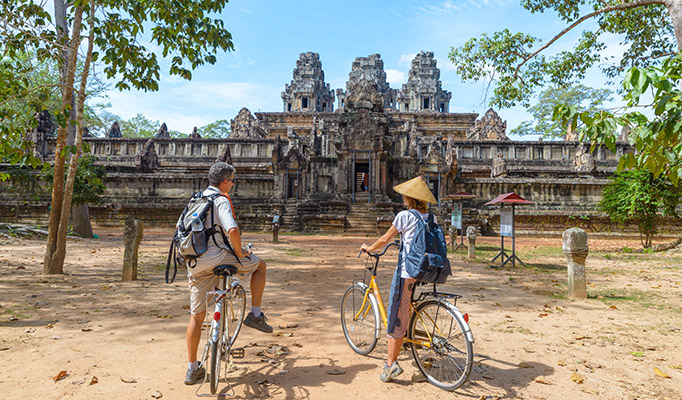 Travellers exploring the ancient temples of Angkor Wat in Cambodia