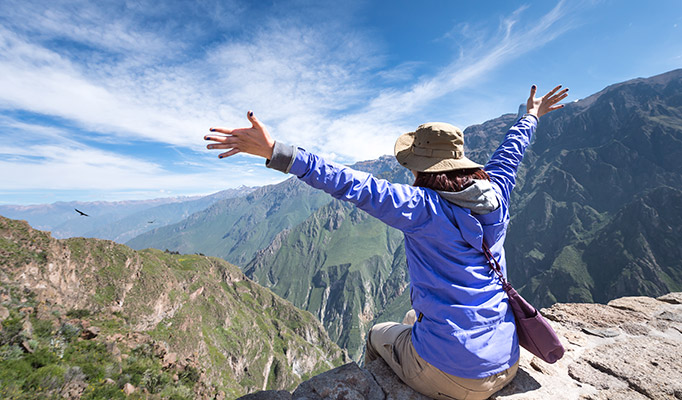 Traveller admiring the view of Colca Canyon in Peru, it's one of the best places to visit in August