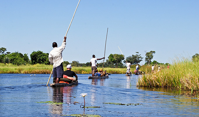 Travellers enjoying a safari on the Okavango Delta, it's one of the best places to go in July