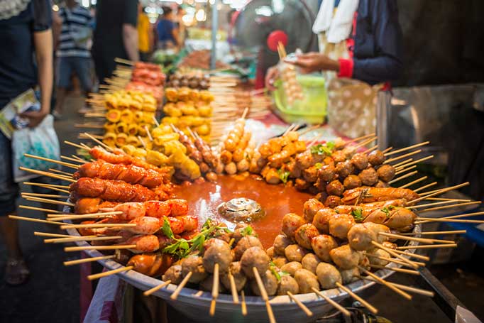 An image of food cooking at Ratchada Rot Fai Market in Bangkok
