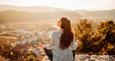 Image of a solo female traveller listening to a podcast