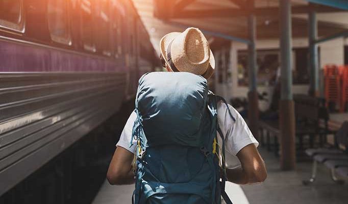 Image of a backpacker in a train station