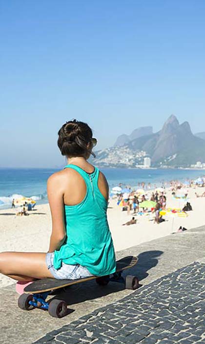 solo female traveller on rio beach looking out to sea and beach