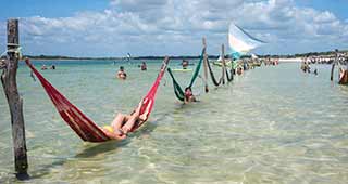 Laze in the hammocks in Jericoaracoara explore brazil on a customizeable holiday through our tailor-made travel style that allows you to travel your way at your own pace like laying in the hammocks of Jericoaracoara