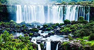 travel on holiday to south america and be amazed as you visit the natural wonder of the world, iguazu falls which crosses from argentina into brazil