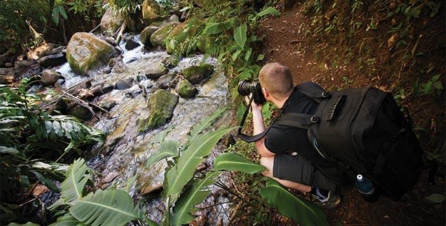 Traveller taking pictures of a stream in Costa Rica
