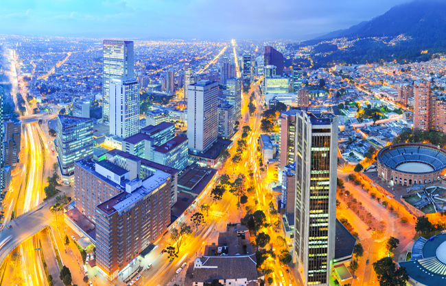 aA nightitme view of the Bogota skyline and the busy traffic flowing through the city's streets