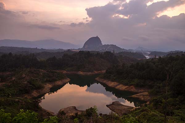 Guatape, Colombia view of rock lake and hills surrounding guatape