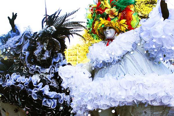 two people dressed in costumes in black and white for carnival of blacks and whites in colombia