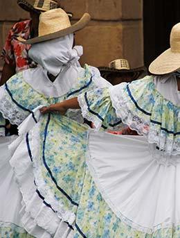 women wearing traditional white dresses and costumes for wayuu culture festival in colombia