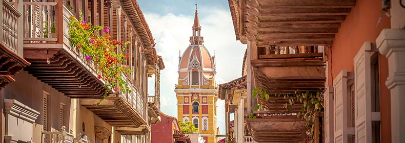 walled ancient city of cartagena colombia leading towards yellow tower
