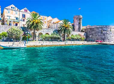 a view of the coast of Korcula showing charming houses and blue sea