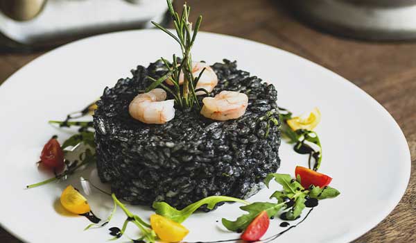 a plate of black risotto in a Croatian restaurant