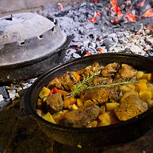 a dish of peka in Croatia with meat and potatoes