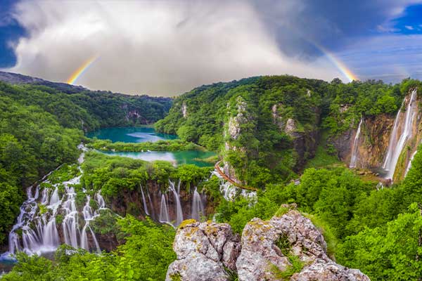 The plitvice national park waterfalls with rainbow in the background