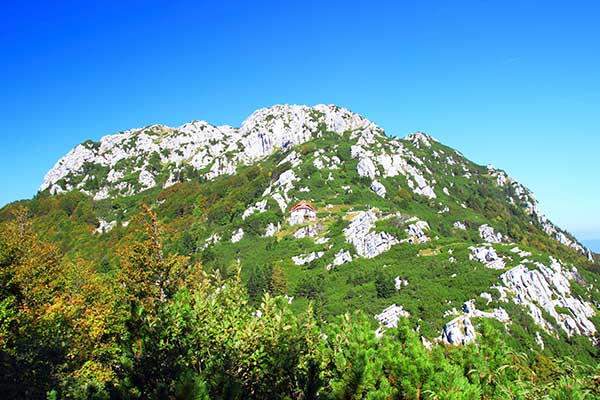 Risnjak National Park, Croatia a lone mountain hut sits amidst the rocky terrain in Risnjak national park