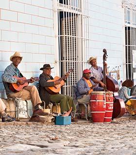 Cuban street music group of cuban men playing instruments in the streets of cuba