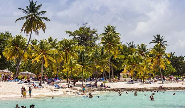 Playa Guardalavaca playa guardalavaca beach in cuba with palm trees and people swimming in the sea