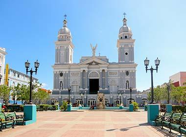 cathedral in square in santiago de cuba on a holiday to cuba blue skies and painted buildings