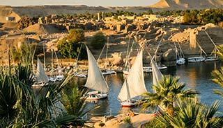 Aswan, Egypt felucca boats sailing along the river nile in egypt