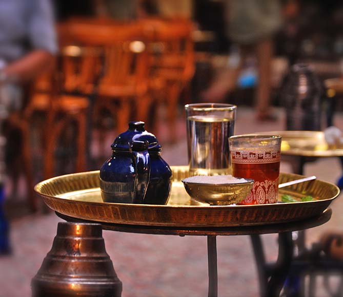 Traditional tea Egypt traditional egyptian tea served on a gold tray with a glass of water