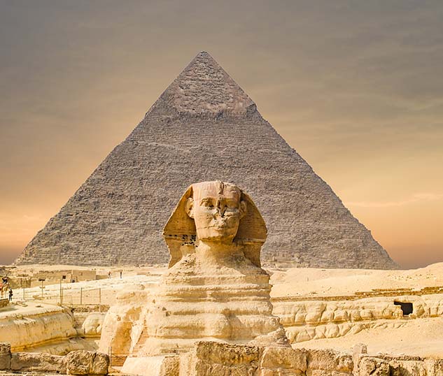 sphinx remains standing in front of the great pyramids of giza outside cairo in egypt