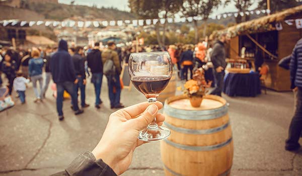 New Wine Festival, Tbilisi, Georgia holding up a glass of georgian red wine at the new wine festival in georgia