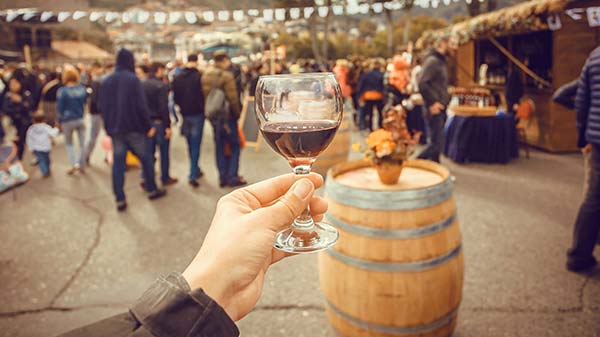 Georgian red wine person holding a glass of georgian red wine at a wine festival in georgia