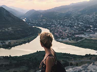 Mtskheta, Georgia woman watching the view of mtskheta town with rivers and mountains