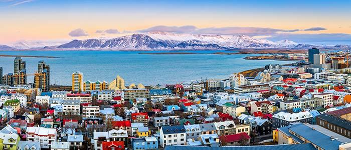 Ariel view of Reykjavik, Iceland aerial view of reykjavik on tour in iceland colourful houses big blue lake mountains in background