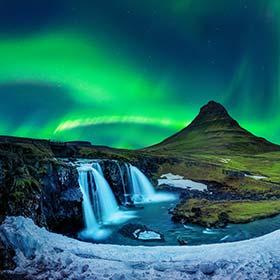 Northern lights at Kirkjufell in Iceland northern lights over kirkjufell mountain waterfalls and ice alongside