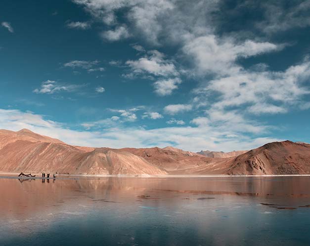 pink mountains dunes and crystal clear lakes in ladakh on a holiday to india
