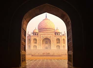 seeing the taj mahal through a doorway in agra on a holiday to india
