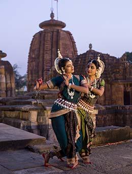 visiting india for adivasi mela festival held in odisha in india with traditional women dancing at temples