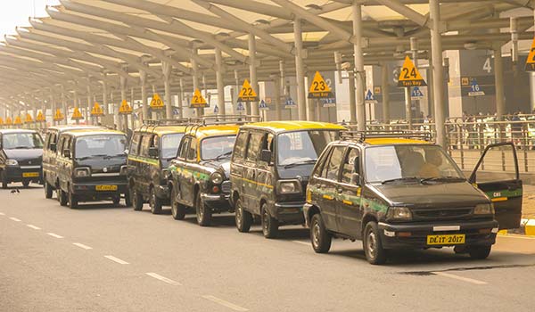 a line of taxis in india at the airport