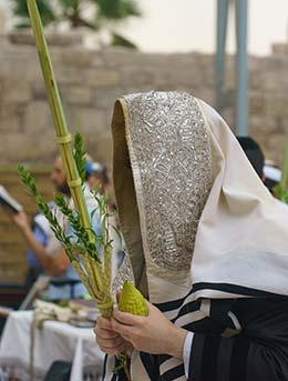 man wearing prayer shawl at birkat kohanim in jerusalem