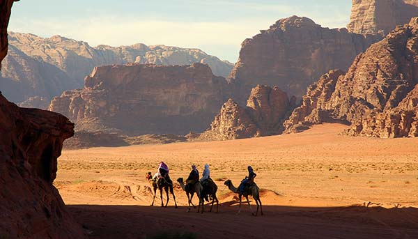 Wadi Rum, Jordan group of people camel trekking in the wadi rum desert in jordan