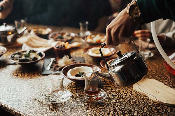 table spread of traditional israeli food on a grey table