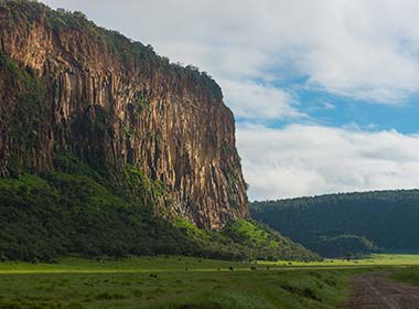 high cliff and green hills of hell's gate national park one of the best places to visit in kenya