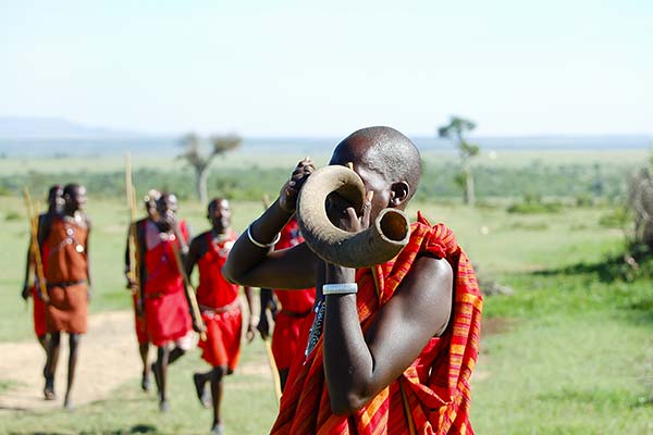 Lake Turkana Festival, Kenya traditional african tribes wearing red blowing horn at lake turkana festival in kenya