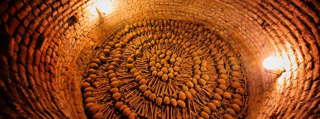 tour group are guided through the catacombs in san francisco church, lima.